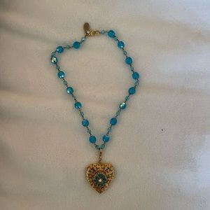 Blue necklace with gold colored locket